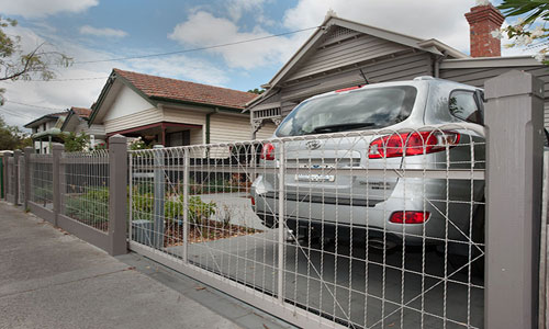 Woven wire fence with sliding gate